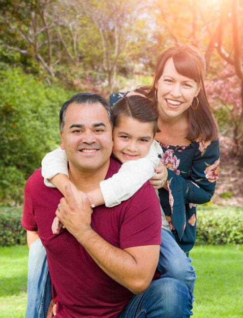 Foto retrato de una familia joven de raza mixta en el parque