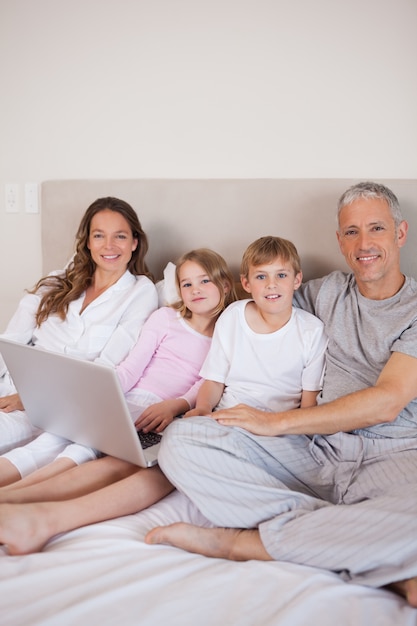 Retrato de una familia usando una computadora portátil