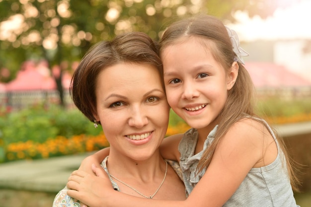 retrato, de, feliz, madre e hija, sonriente, aire libre