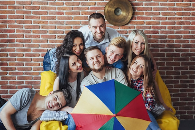 Retrato de grupo de niños y niñas multiétnicos con ropa colorida de moda con un amigo posando en una pared de ladrillo, gente de estilo urbano divirtiéndose, s sobre el estilo de vida de la juventud