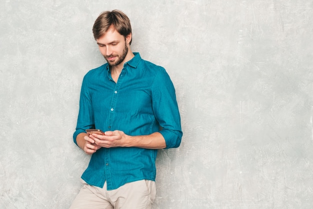 Retrato de guapo sonriente hipster lumbersexual modelo de hombre de negocios vistiendo ropa casual camisa de jeans.