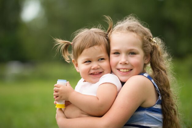 Retrato de hermanitas felices en el parque