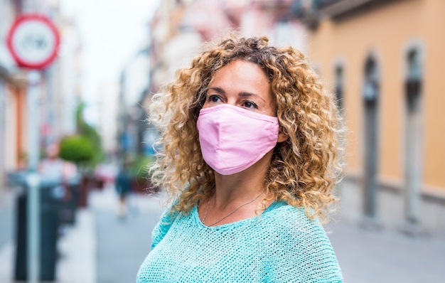 Retrato de hermosa mujer adulta caucásica usa máscara de protección durante coronavirus covid