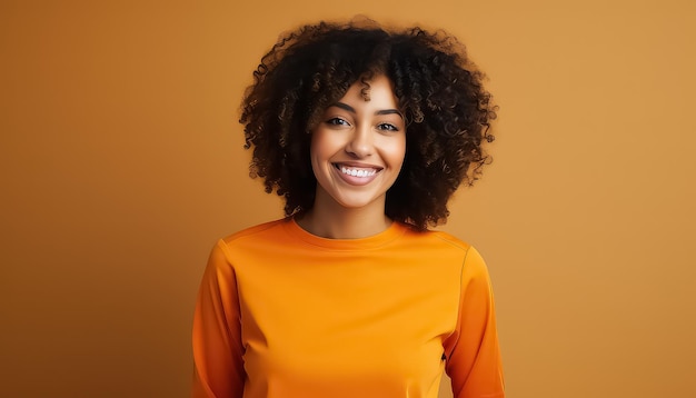 retrato de una hermosa mujer africana de pie contra el fondo naranja