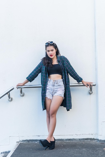 Retrato de una hermosa mujer asiática Chica de hipsters en la escalera para tomar una foto Gente de Tailandia