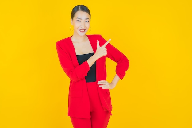 Retrato hermosa mujer asiática joven sonrisa con acción en amarillo