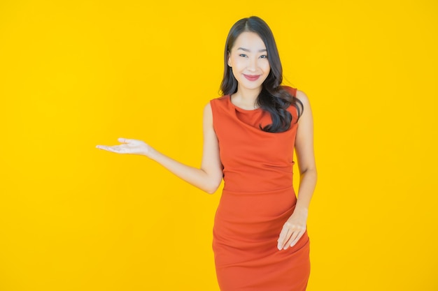 Retrato hermosa mujer asiática joven sonrisa en amarillo