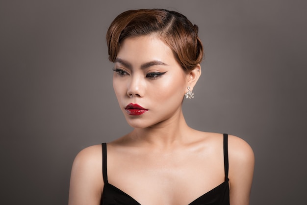 Retrato de hermosa mujer asiática sensual con peinado elegante y maquillaje perfecto.