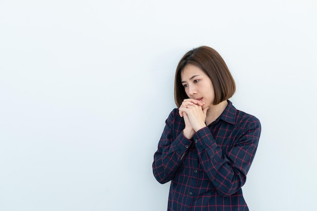 Retrato de una hermosa mujer asiática triste y estresada por el fondo blanco. La gente de Tailandia es seria y se preocupa por el amor. Una chica piensa en el concepto.