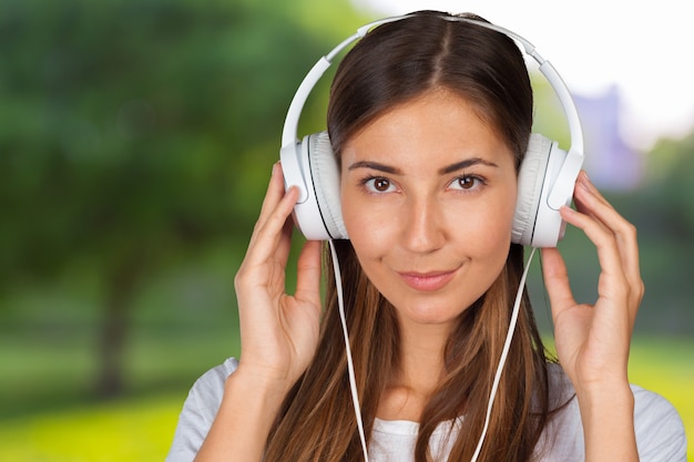 Retrato de una hermosa mujer estudiante escuchando música