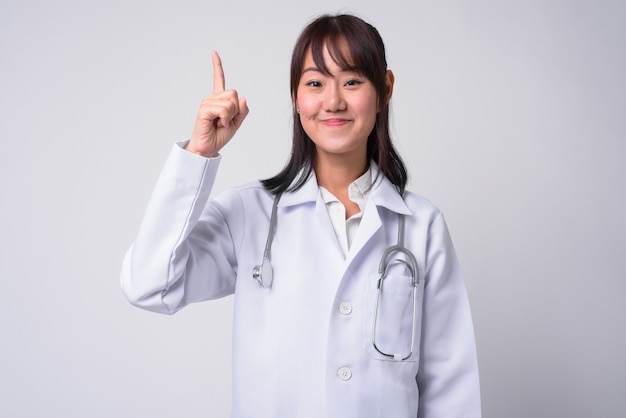 Retrato de hermosa mujer japonesa médico en blanco