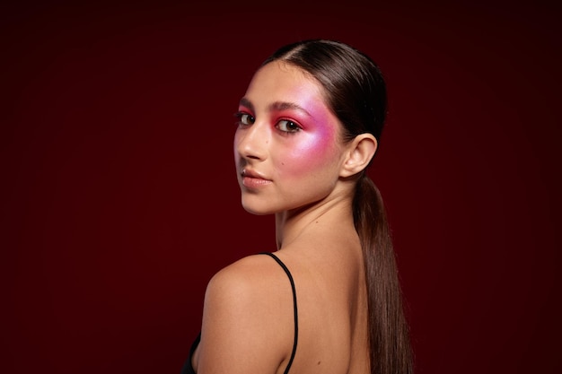 Retrato de hermosa mujer joven camiseta negra rosa maquillaje cosméticos moda primer plano inalterado