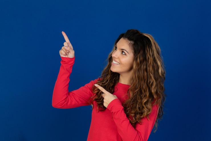 Foto retrato de hermosa niña caucásica con pelo rizado aislado en una pared blanca