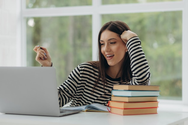 Retrato de una hermosa niña estudiando en casa