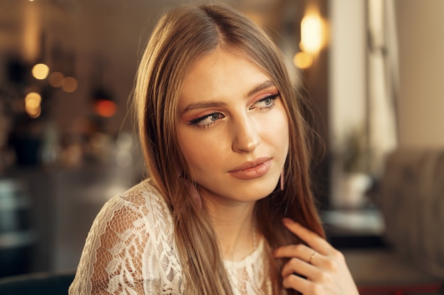 Retrato hermoso modelo femenino en un café