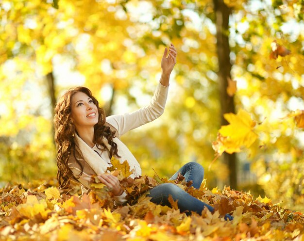 retrato, de, hermoso, mujer joven, posar, en, otoño, parque