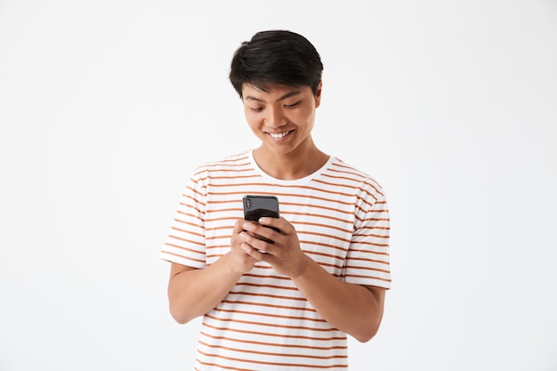 Retrato de un hombre asiático sonriente sosteniendo un teléfono móvil