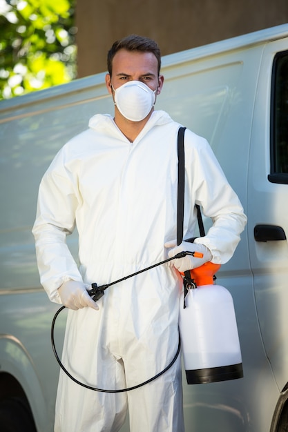 Foto retrato de hombre de control de plagas de pie junto a una camioneta