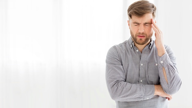 Foto retrato hombre con dolor de cabeza con espacio de copia