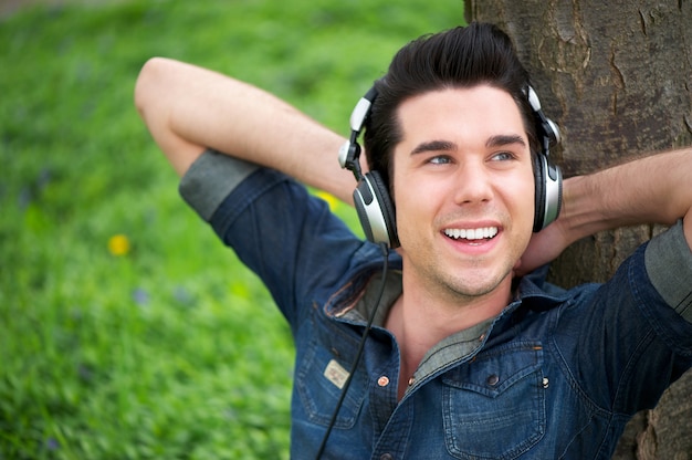 Retrato de un hombre feliz escuchando música al aire libre