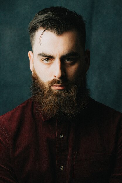 Foto retrato de un hombre guapo con barba, estilo hipster, conceptos serios, coloridos, de belleza y estilo, estilo de vida