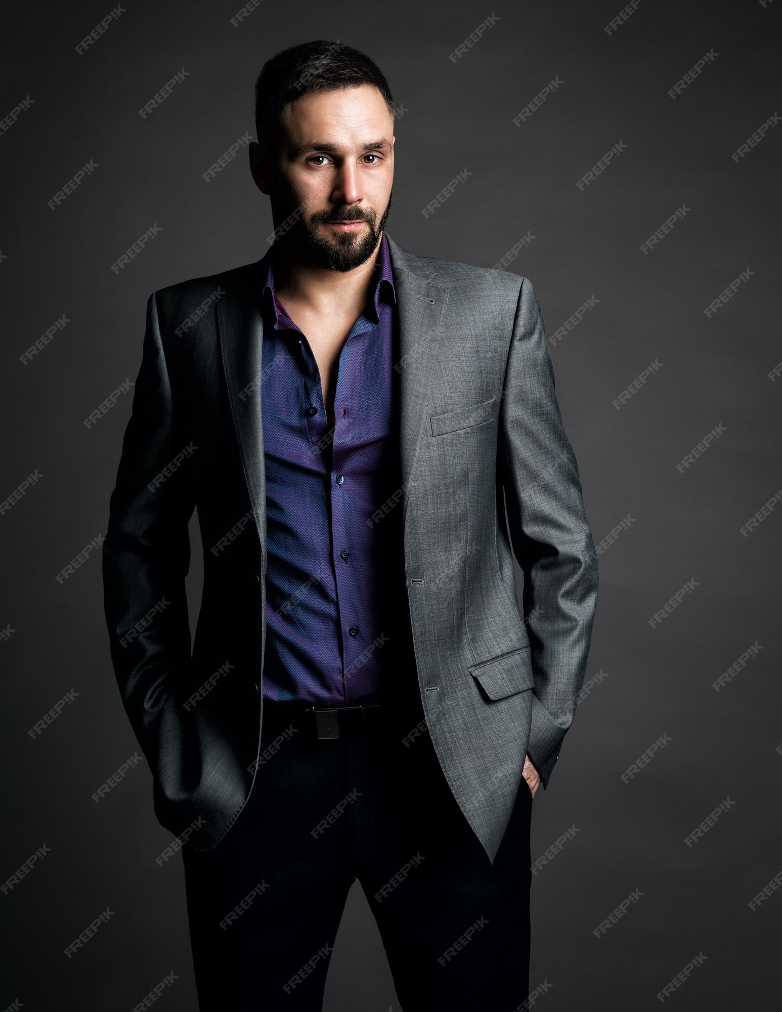 Retrato de guapo con barba de moda hombres con confiados en camisa traje gris sobre fondo oscuro Foto Premium