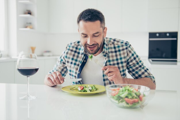 Foto retrato de hombre guapo comiendo en casa