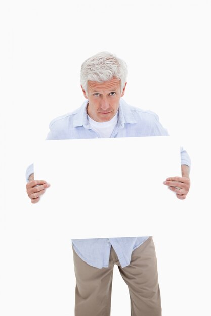 Foto retrato de un hombre maduro con una tabla en blanco