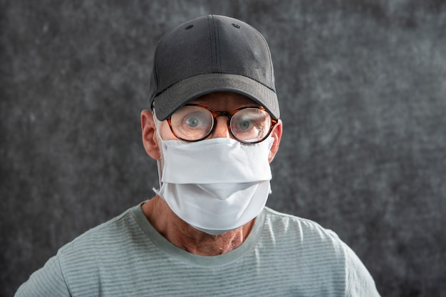 Retrato de un hombre mayor con una máscara médica