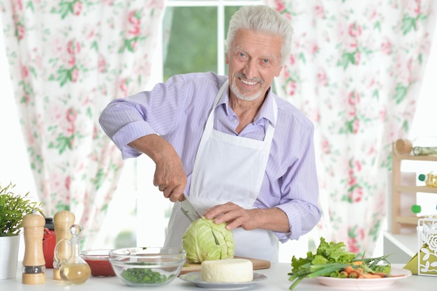 retrato, de, hombre mayor, preparando, cena, en, cocina