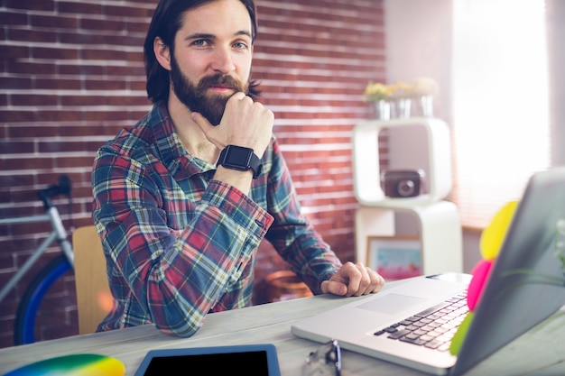 Retrato de hombre de negocios confidente con tableta gráfica y portátil