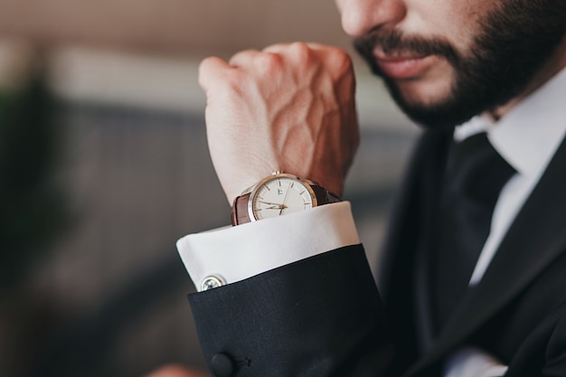 Retrato de hombre de negocios guapo con reloj clásico