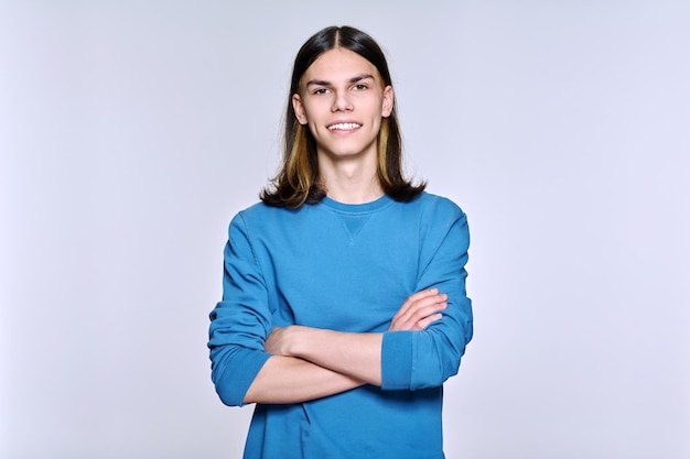 Retrato de hombre positivo sonriente mirando a la cámara sobre fondo claro