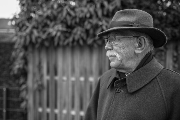 Foto retrato de un hombre con sombrero de pie al aire libre