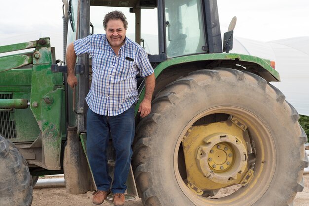 Retrato de un hombre sonriente de pie junto al coche