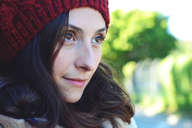 Retrato del invierno de la mujer contra una pared de ladrillo.