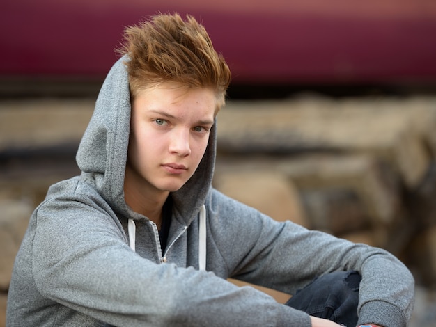 Retrato de joven adolescente guapo en la estación de tren