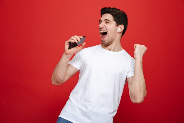 Foto retrato de un joven alegre en camiseta blanca