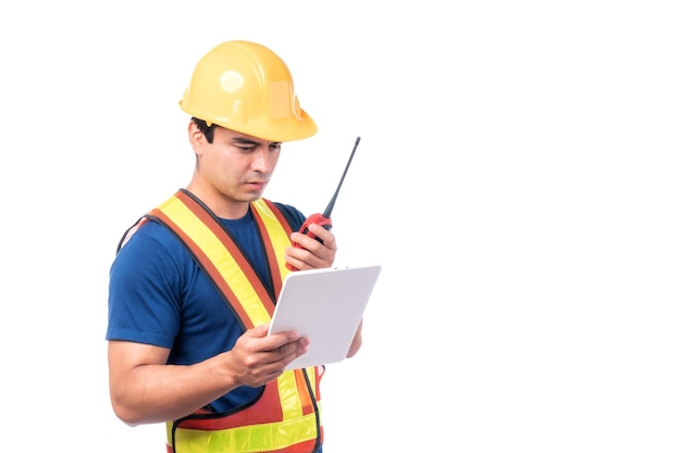 Retrato joven arquitecto hombre ingeniería con casco amarillo sosteniendo megáfono y tableta en la mano Él de pie con los brazos cruzados aislado sobre fondo blanco con espacio de copia