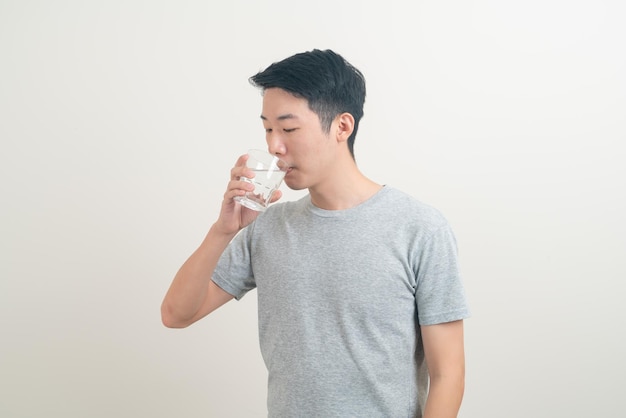 Retrato joven asiático con un vaso de agua en la mano