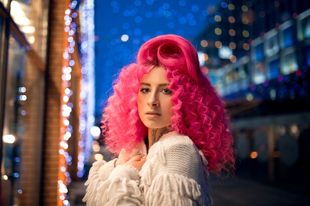 Retrato joven atractivo modelo de chica caucásica con pelo rosa brillante rizado estilo afro