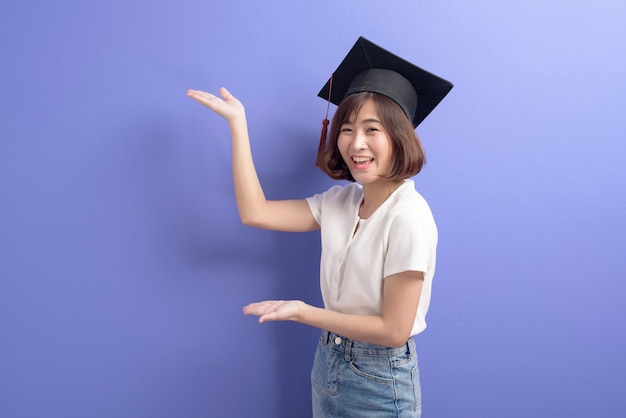 Un retrato de un joven estudiante asiático con gorro de graduación.