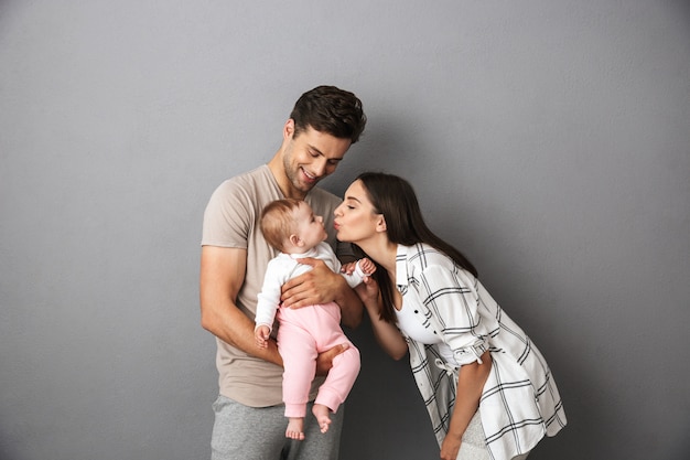 Retrato de una joven familia feliz con su pequeña niña