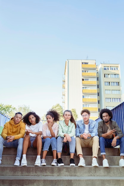 Retrato de un joven grupo de amigos sentados en las escaleras