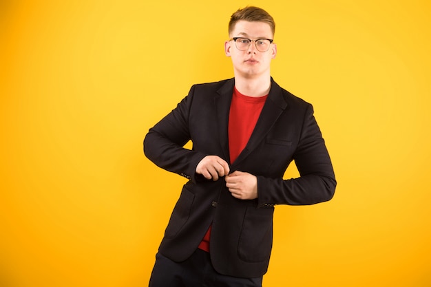 Retrato de joven guapo confiado con las manos en su chaqueta