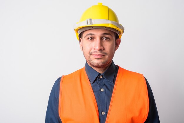 Retrato de joven guapo trabajador de la construcción iraní en blanco