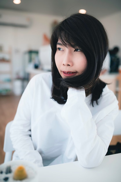 Retrato de joven hermosa mujer asiática en la cafetería