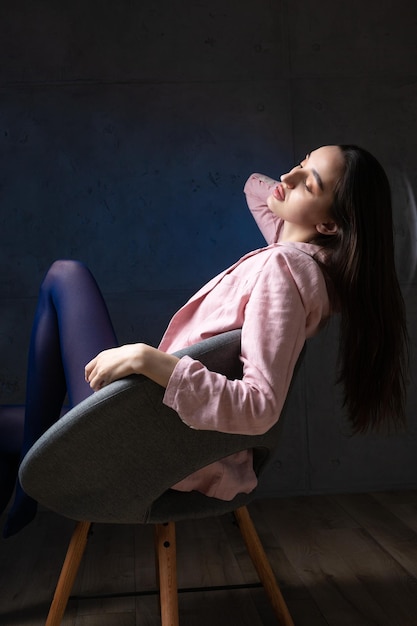 Retrato de una joven morena con cabello largo en el estudio Foto dramática en colores oscuros