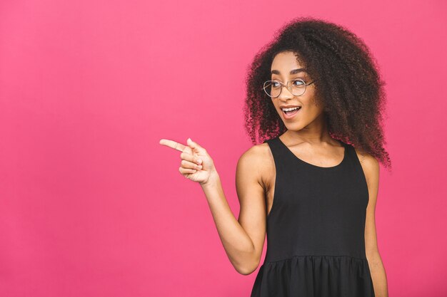 Retrato de una joven mujer afroamericana feliz apuntando