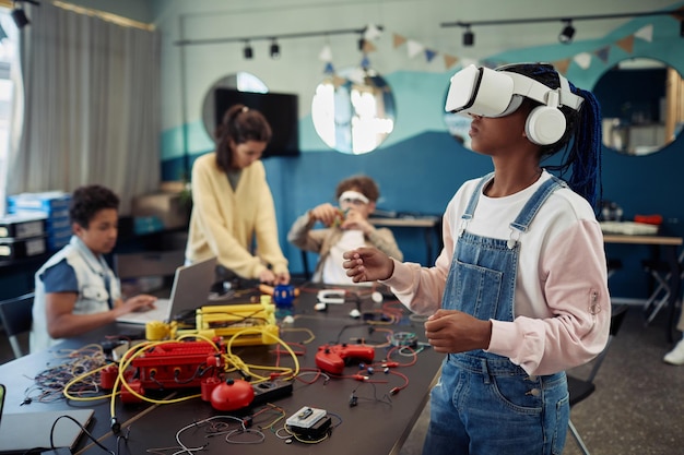 Retrato de una joven negra que usa tecnología vr en el espacio de copia de la clase de ingeniería